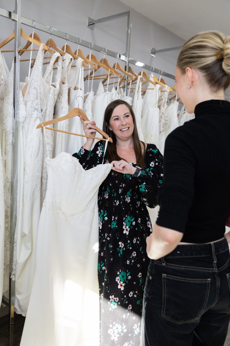 VBB consultant showing a wedding dress from the rail