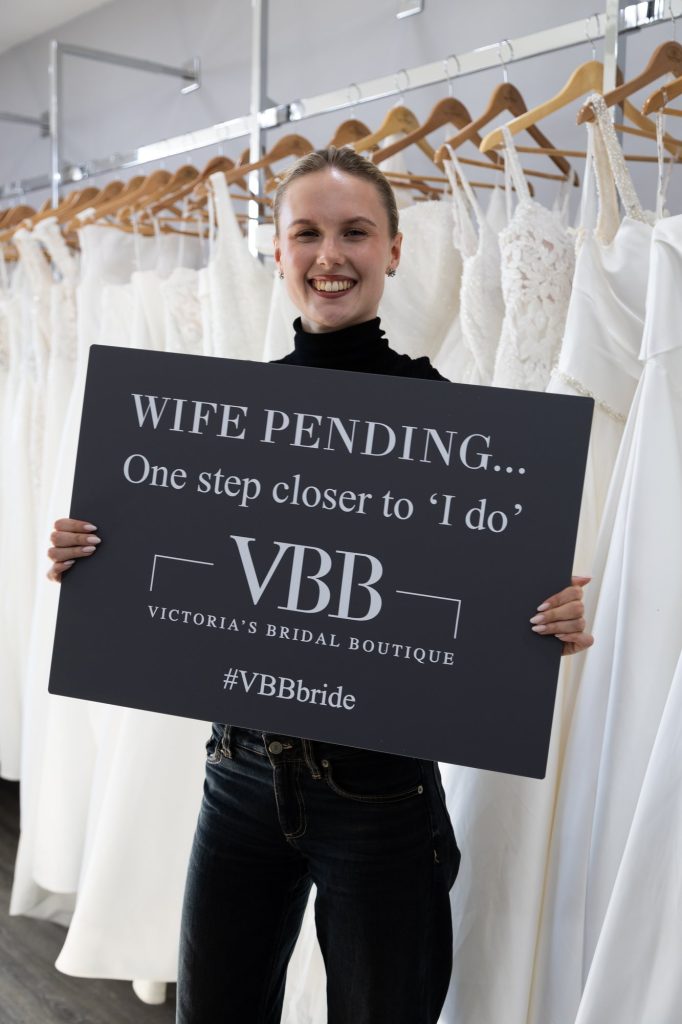 Bride holding a Wife Pending sign at VBB
